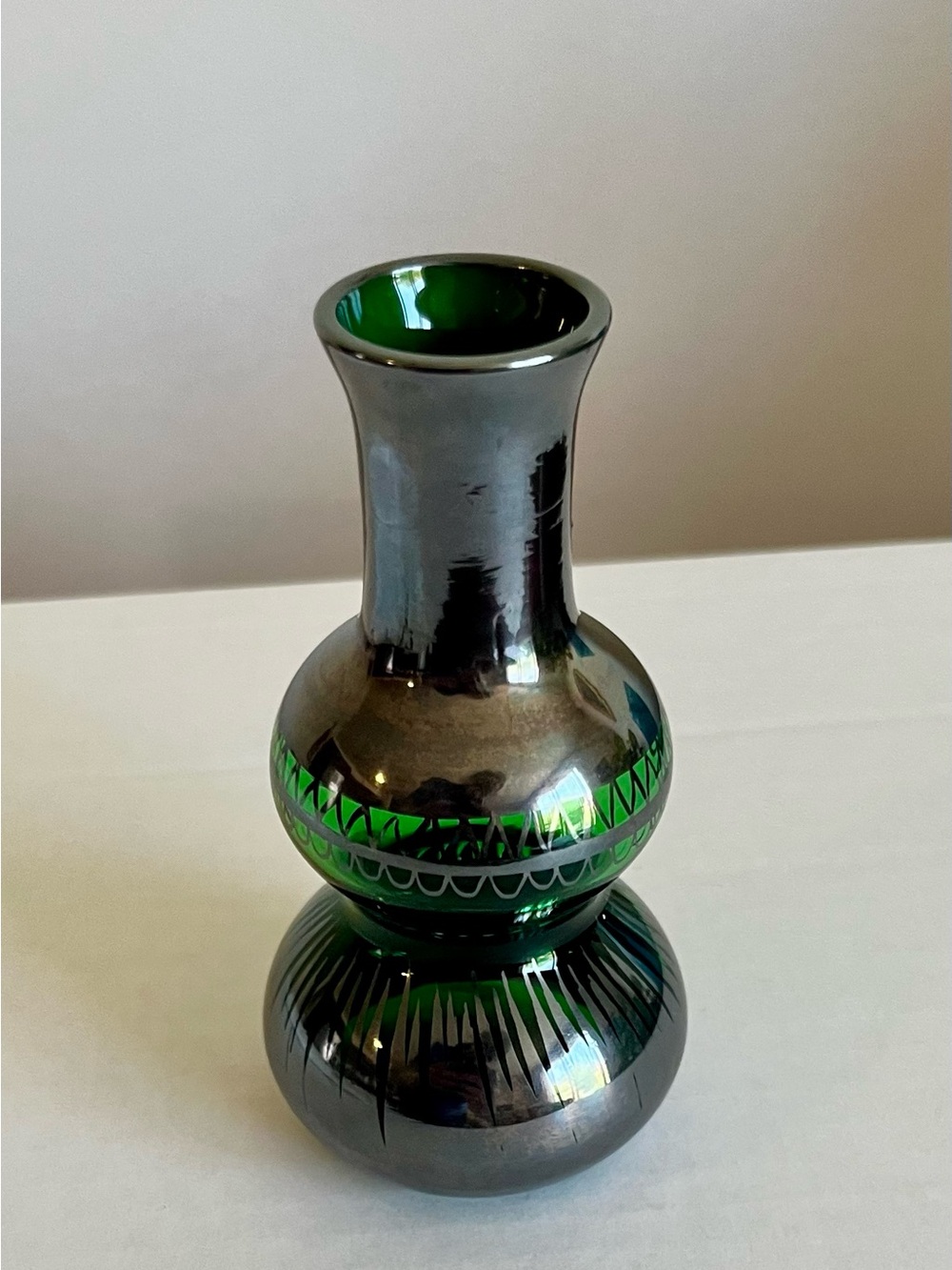 Vintage green glass bud vase with silver overlay. Approximately 4” tall.